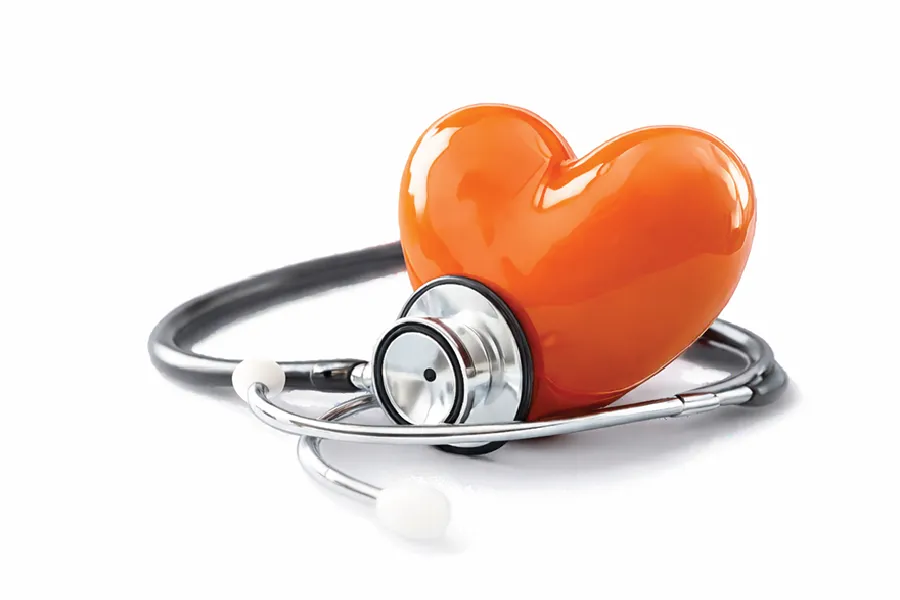 Orange heart under a stethoscope, symbolizing heart health and medical care