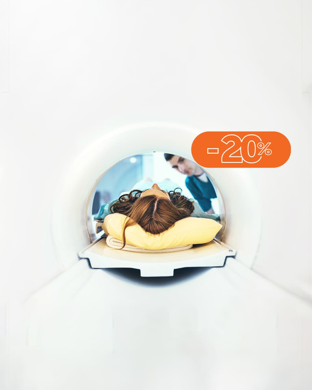 Person lying in an MRI scanner with a yellow pillow, a promotional orange -20% badge over the image