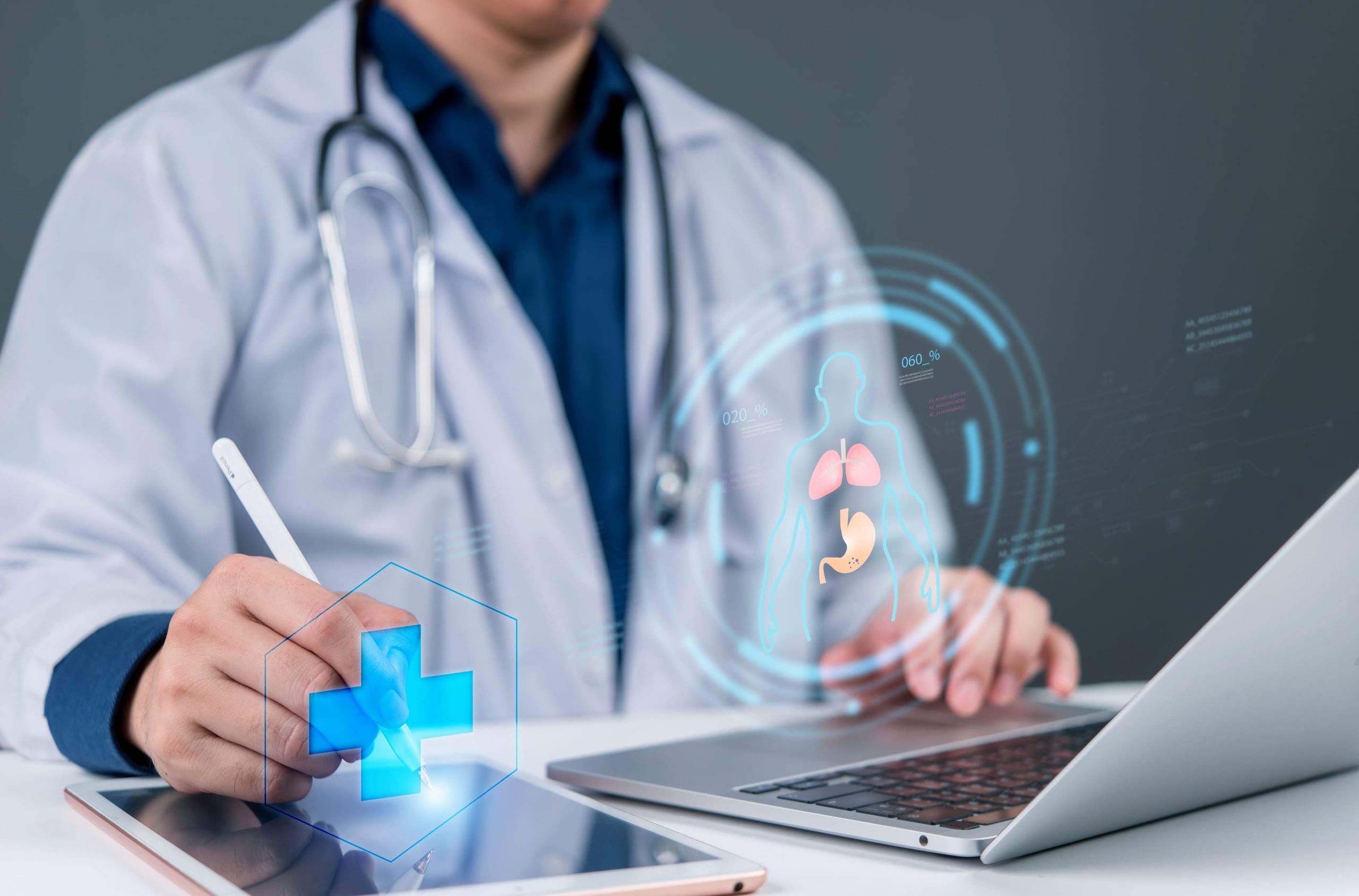 Doctor in a white coat using a tablet with AR medical graphics projected in front of them, stethoscope nearby